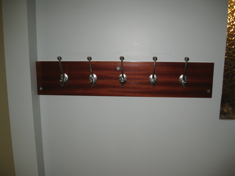 Pilltop coat hooks mounted to bloodwood backboard.